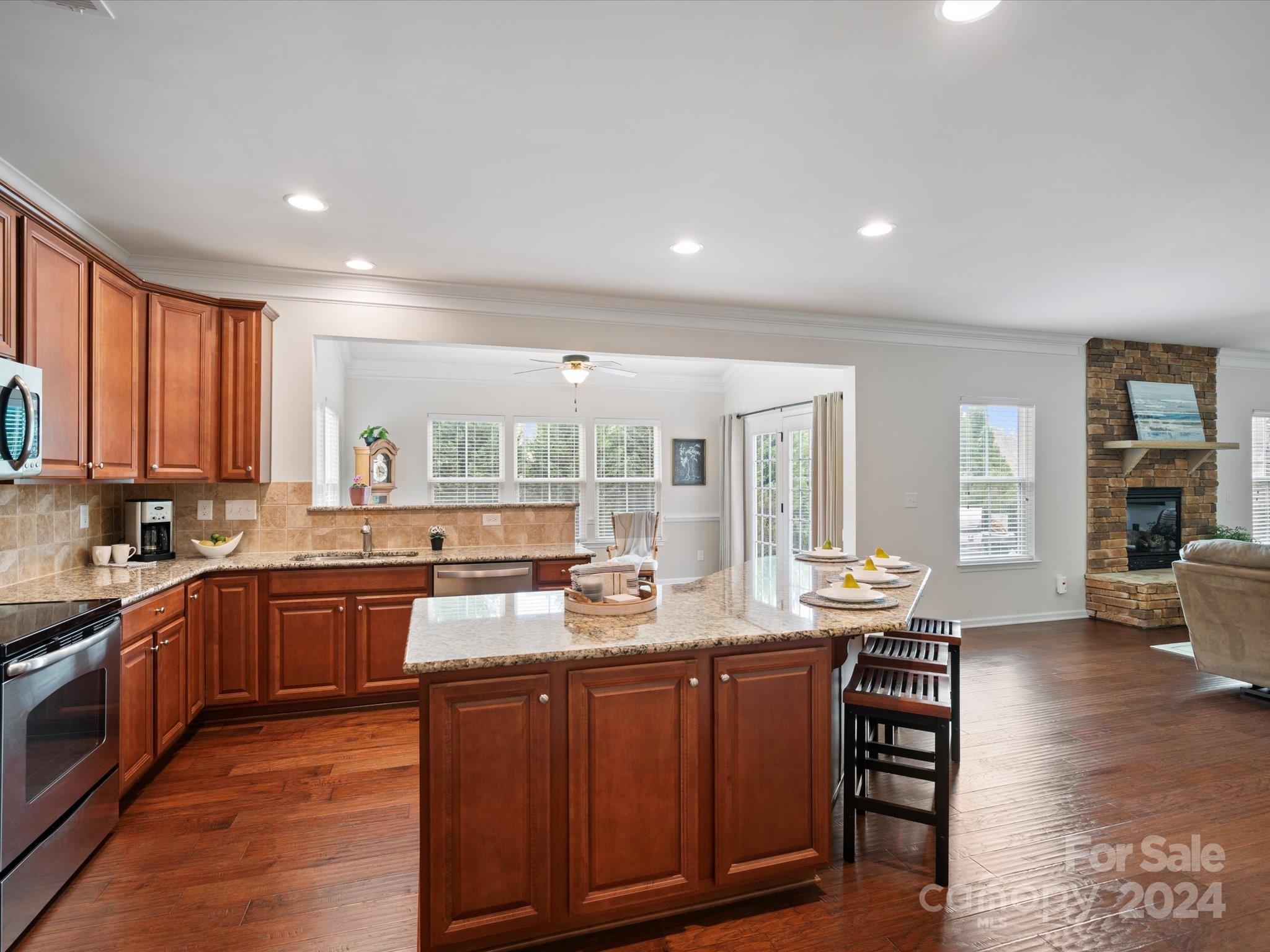 1617 Ridgehaven Road Waxhaw, NC 28173 - Photo 12 of 47 a large kitchen with granite countertop a large counter top furniture and stainless steel appliances