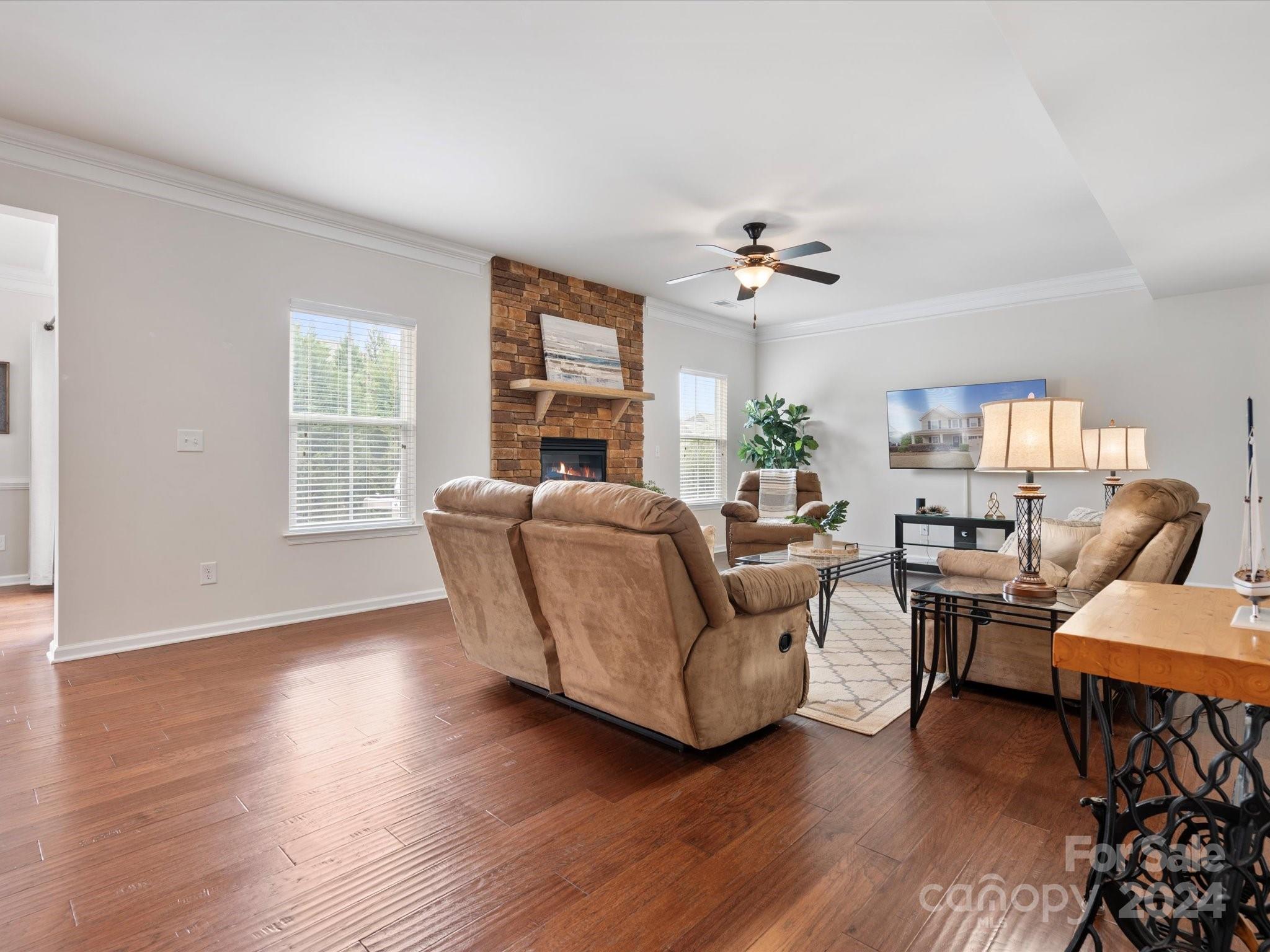 1617 Ridgehaven Road Waxhaw, NC 28173 - Photo 17 of 47 a living room with furniture a chandelier and wooden floor