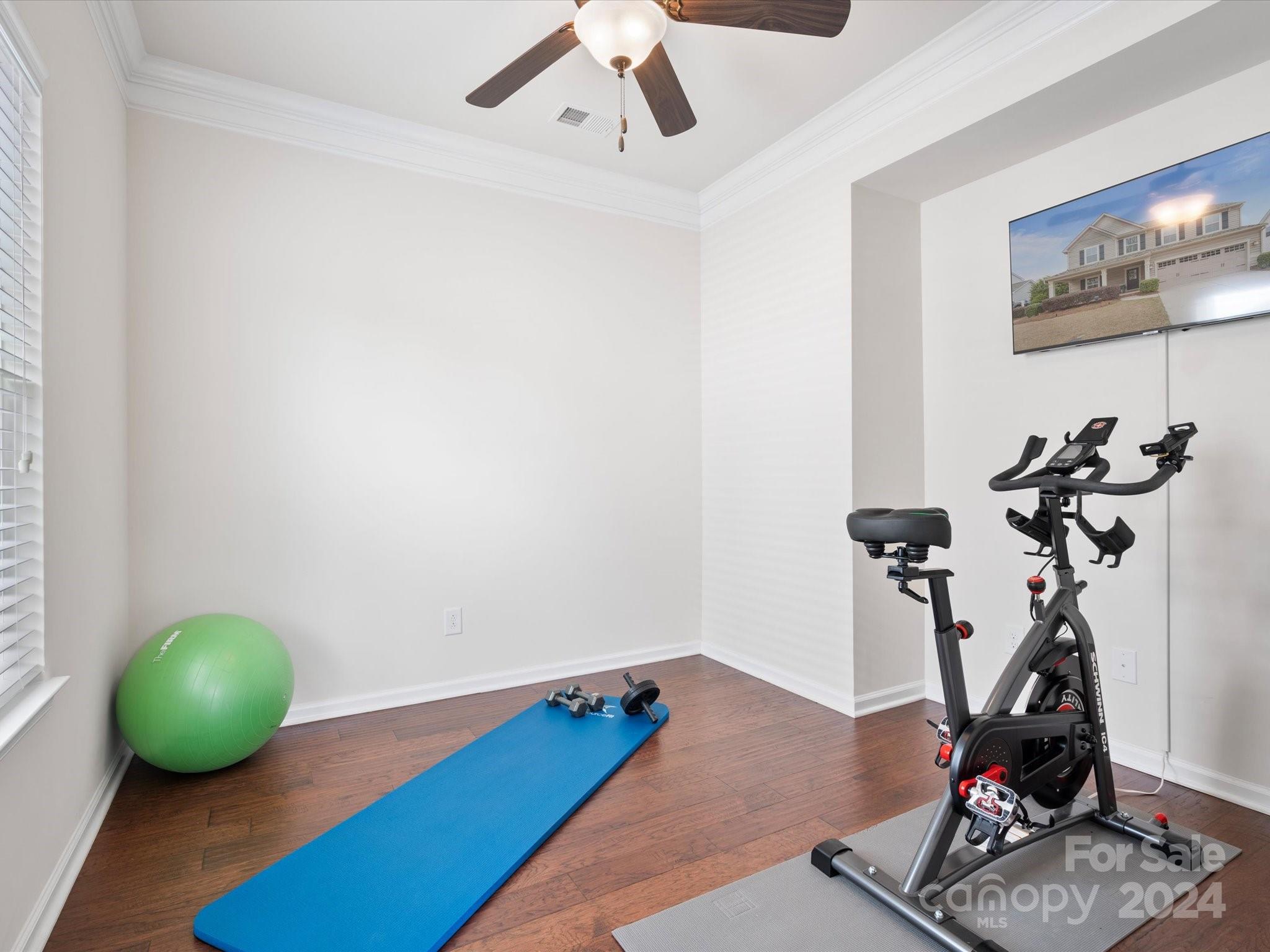 1617 Ridgehaven Road Waxhaw, NC 28173 - Photo 22 of 47 a room with gym equipment and wooden floor
