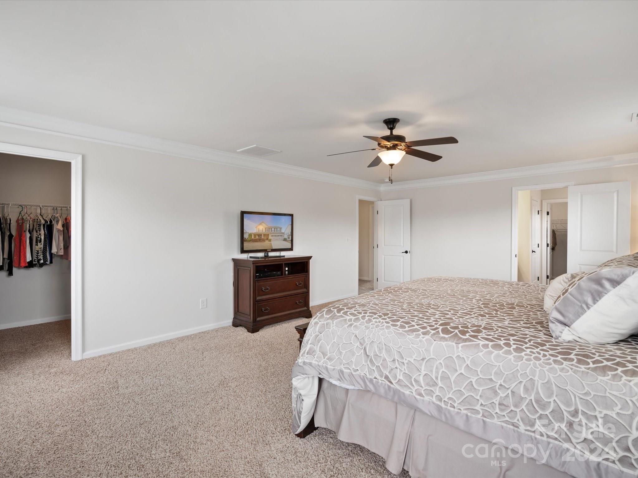 1617 Ridgehaven Road Waxhaw, NC 28173 - Photo 25 of 47 a bedroom with a large bed a chandelier and a chandelier