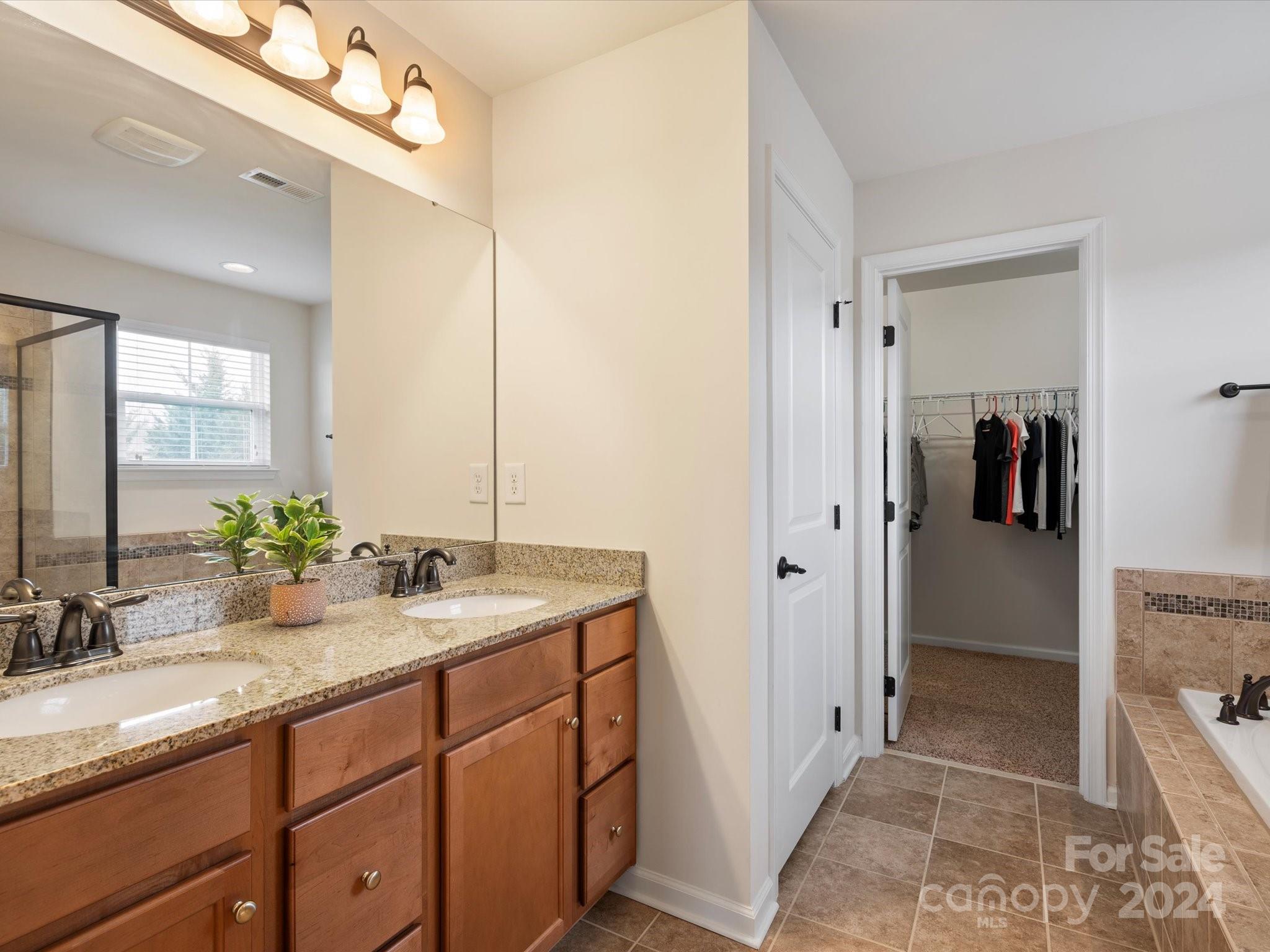 1617 Ridgehaven Road Waxhaw, NC 28173 - Photo 26 of 47 a bathroom with a sink and a mirror