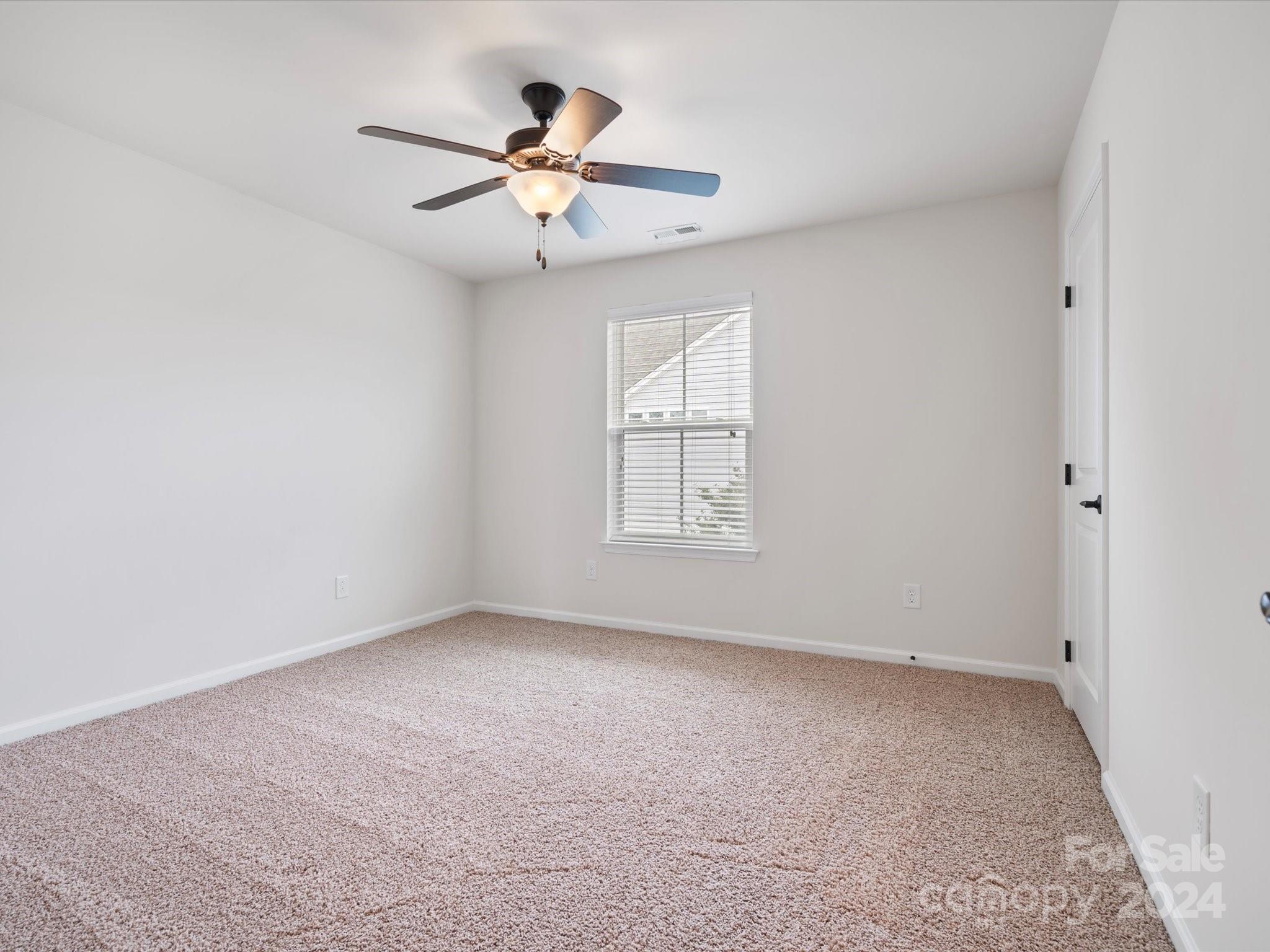 1617 Ridgehaven Road Waxhaw, NC 28173 - Photo 29 of 47 an empty room with windows and ceiling fan