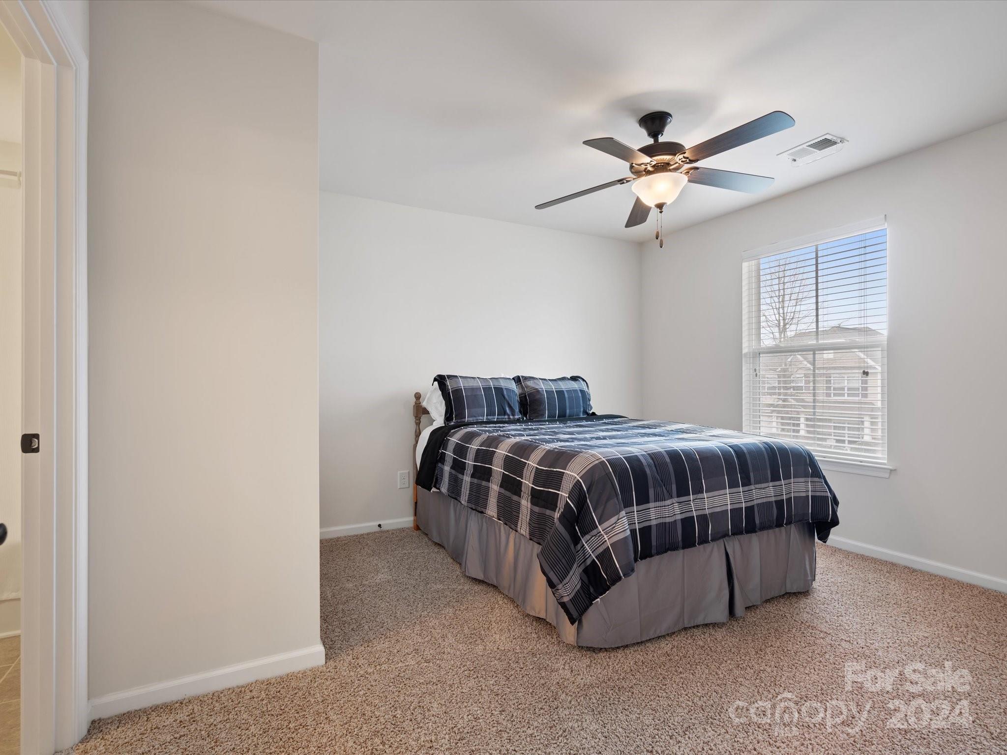 1617 Ridgehaven Road Waxhaw, NC 28173 - Photo 34 of 47 a spacious bedroom with a bed and window