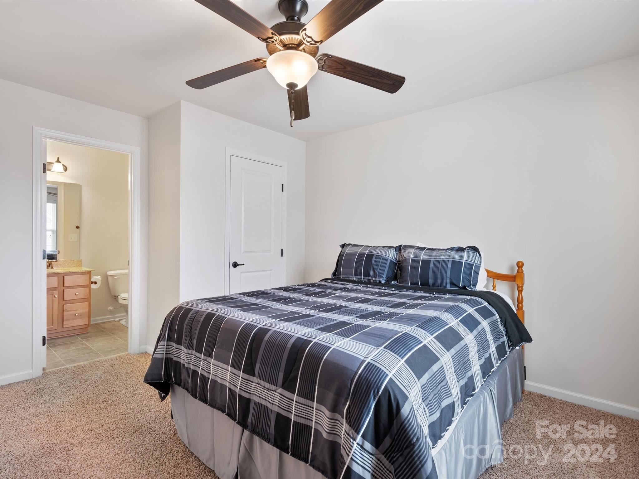 1617 Ridgehaven Road Waxhaw, NC 28173 - Photo 35 of 47 a bedroom with a bed and a chandelier