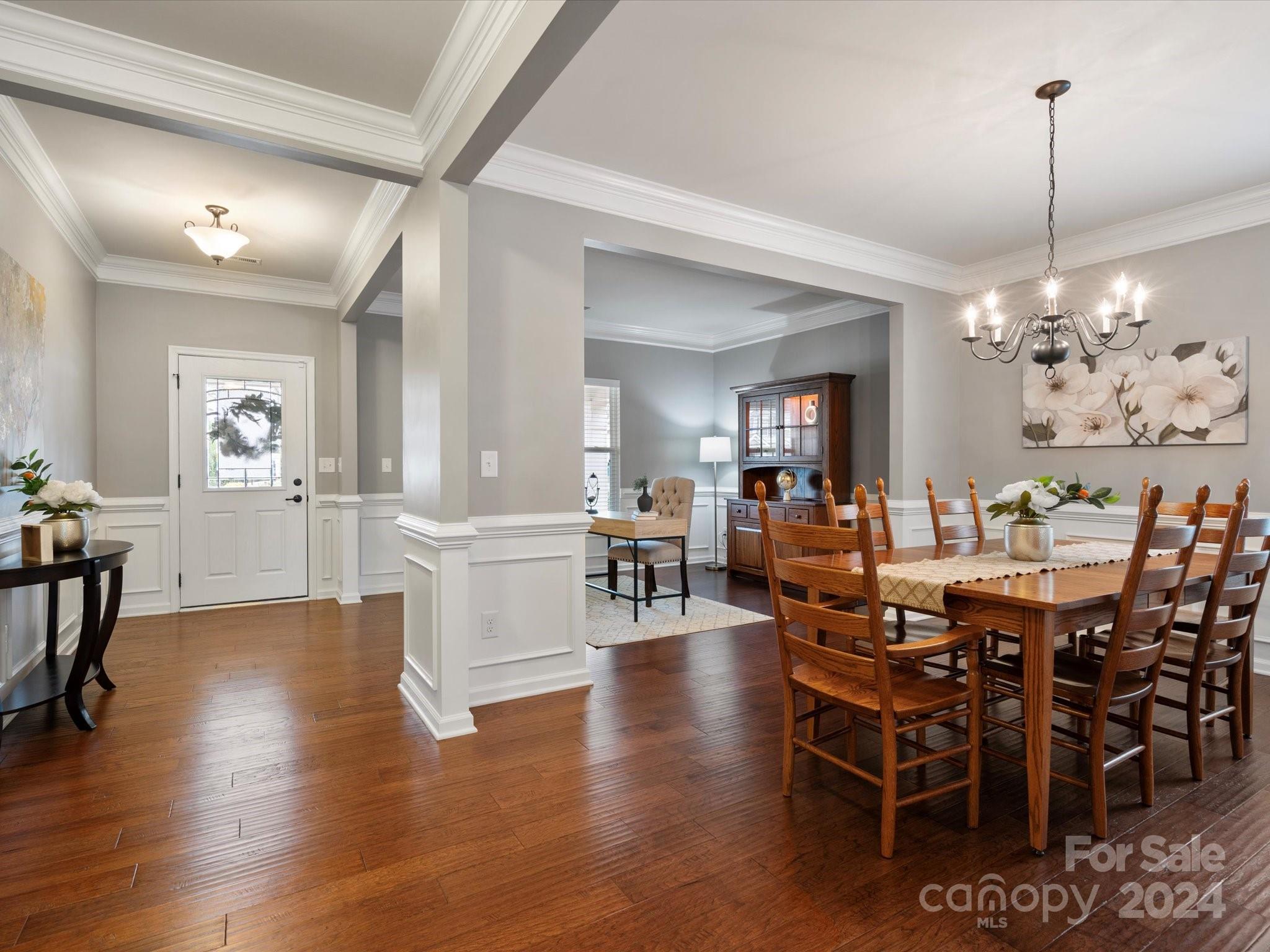1617 Ridgehaven Road Waxhaw, NC 28173 - Photo 8 of 47 a view of a dining room and livingroom with furniture wooden floor a chandelier