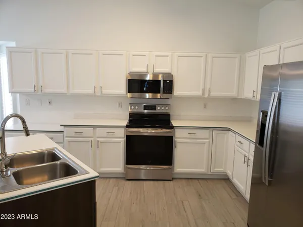 a kitchen with a sink stove and refrigerator
