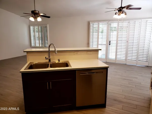 a kitchen with a sink cabinets and a window