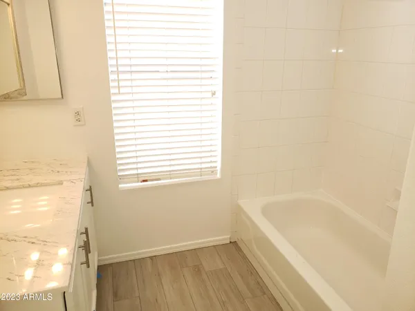 a white bath tub sitting next to a window