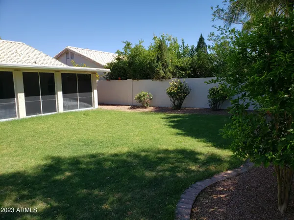 a view of a house with a wooden fence