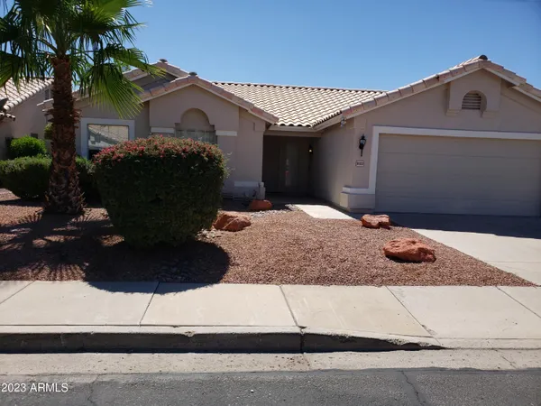 a view of a house with a yard and garage