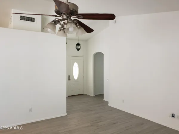 a view of a room with a hanging light and kitchen