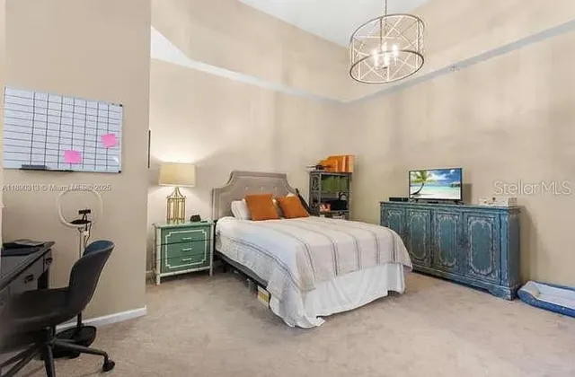 a bedroom with a bed and a chair in it