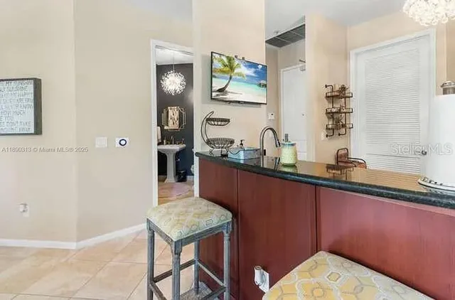 a kitchen with stainless steel appliances granite countertop a sink a stove and refrigerator