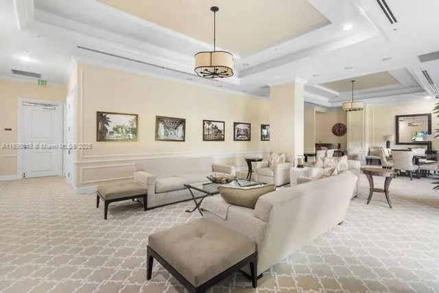 a living room with furniture and a chandelier