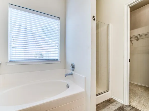 a white bath tub sitting next to a window