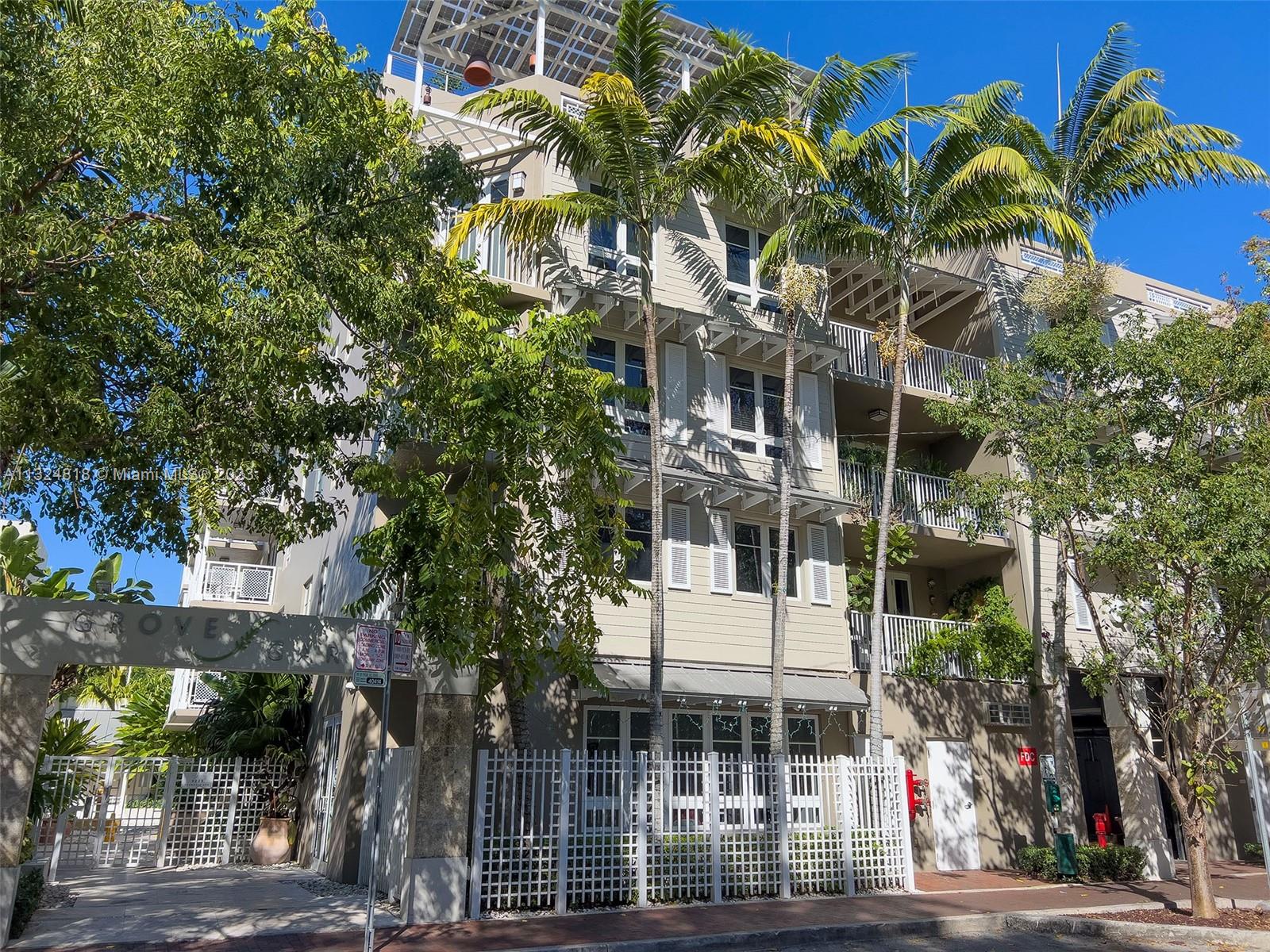 3540 Main Highway, Unit 202 Miami, FL 33133 - Photo 1 of 30 a front view of a building with a tree