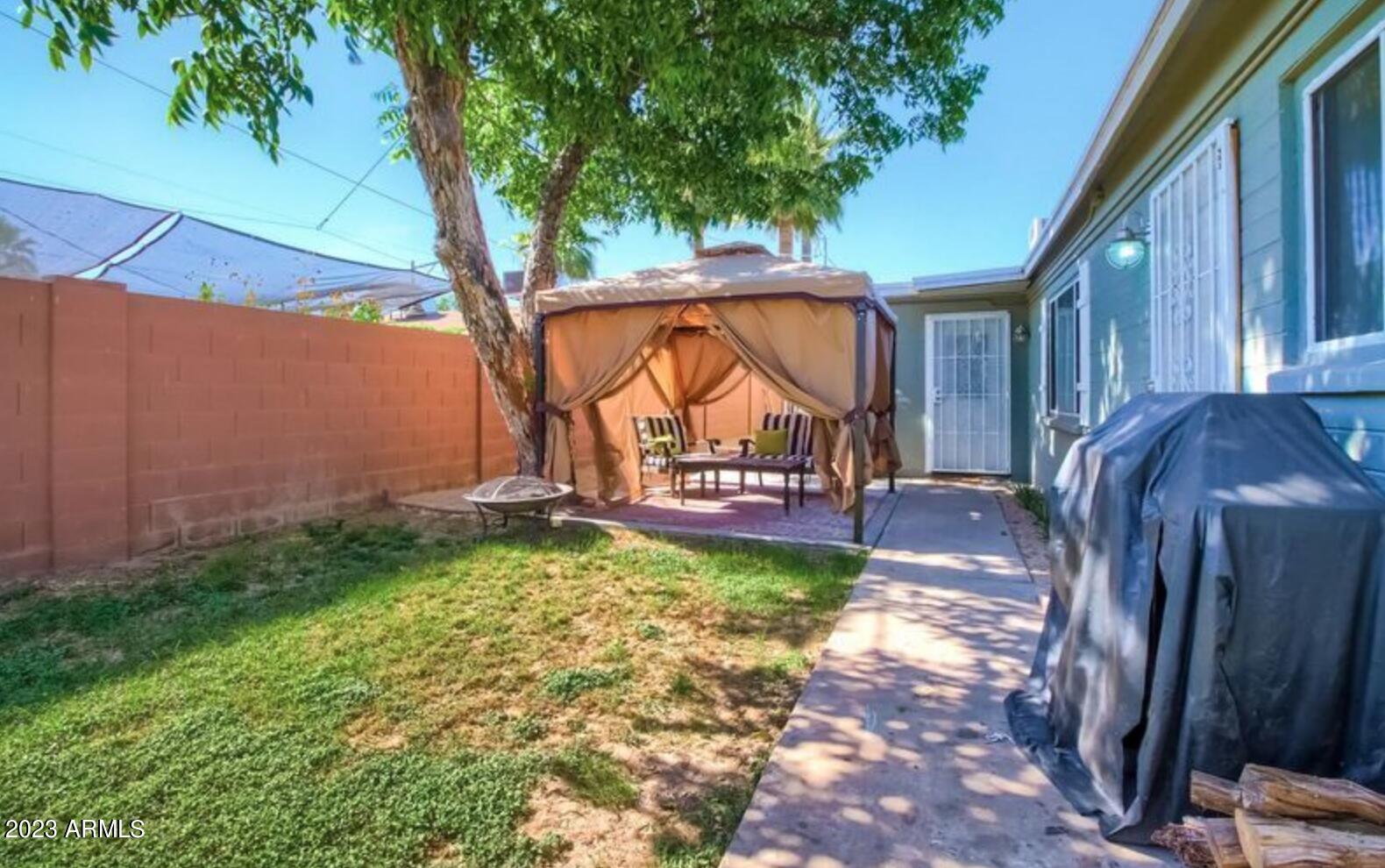 1430 East Meadowbrook Avenue Phoenix, AZ 85014 - Photo 11 of 18 a view of a yard with furniture and a yard