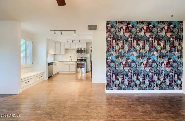 a view of a kitchen with cabinets and wooden floor