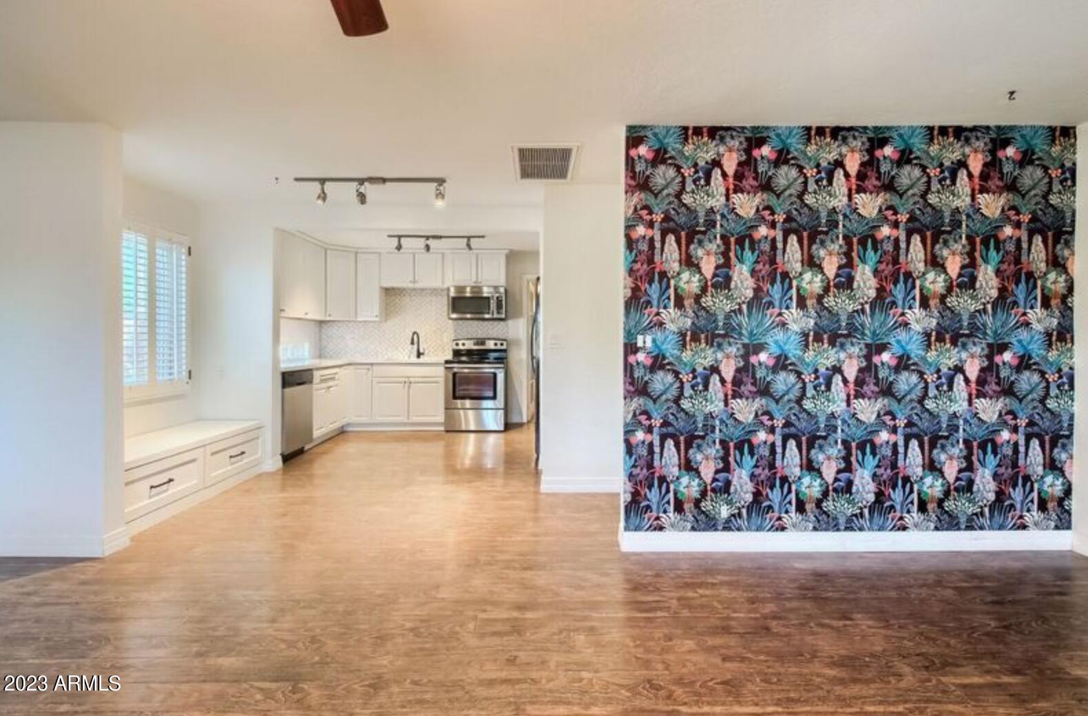 1430 East Meadowbrook Avenue Phoenix, AZ 85014 - Photo 2 of 18 a view of a kitchen with cabinets and wooden floor
