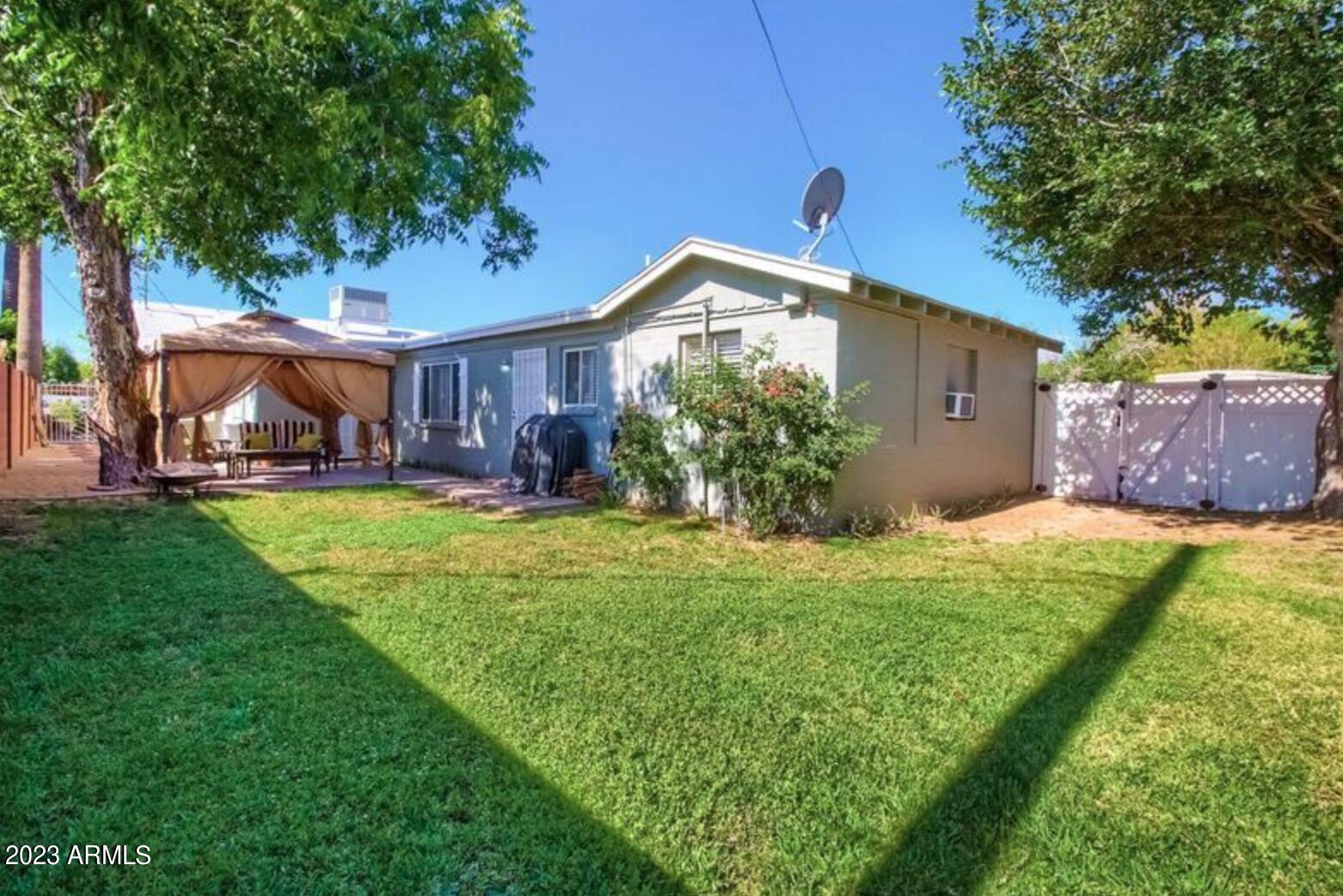 1430 East Meadowbrook Avenue Phoenix, AZ 85014 - Photo 10 of 18 a front view of a house with garden