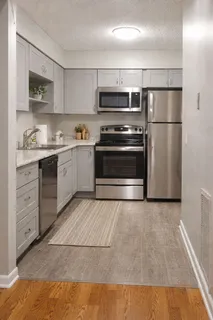 a kitchen with stainless steel appliances granite countertop a refrigerator sink and stove