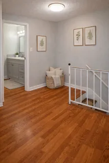 a big room with wooden floor and windows