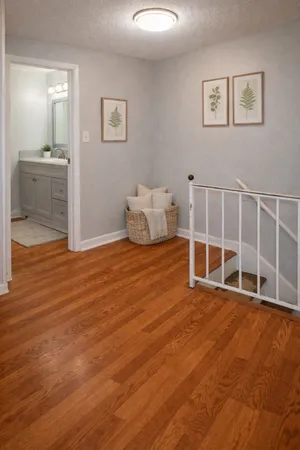 a big room with wooden floor and windows