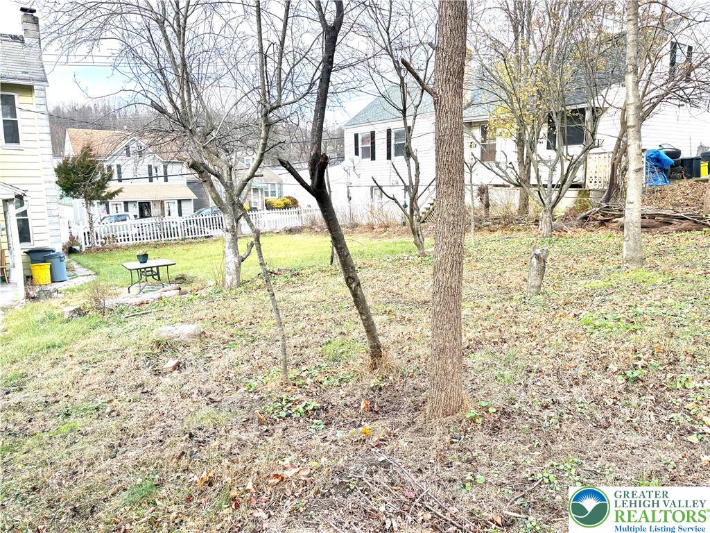 346 Messinger Street Bangor, PA 18013 - Photo 26 of 26 a view of yellow house with trees in the background