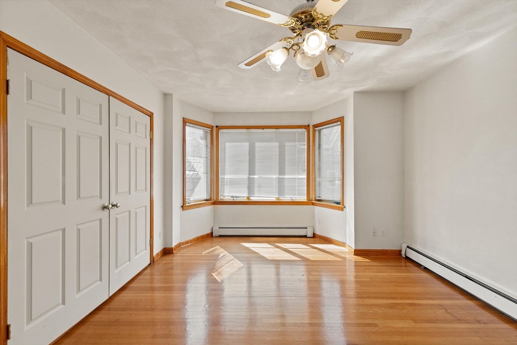 5 Washington Square Gloucester, MA 01930 - Photo 3 of 20 a view of an empty room with window and chandelier fan