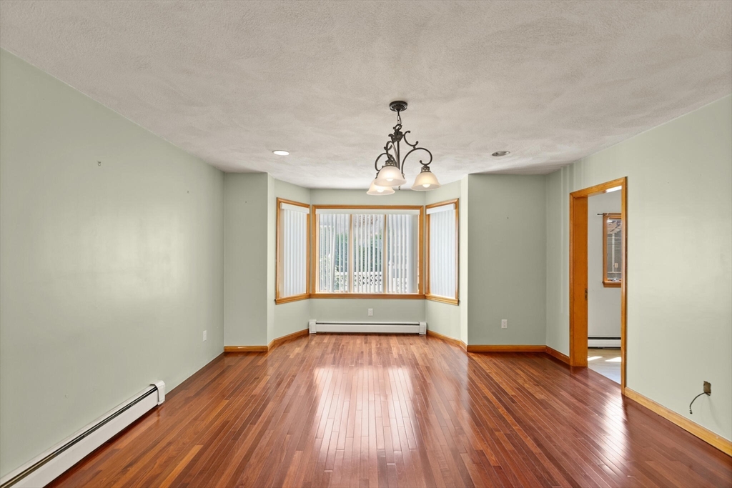 5 Washington Square Gloucester, MA 01930 - Photo 4 of 20 a view of an empty room with wooden floor and a window