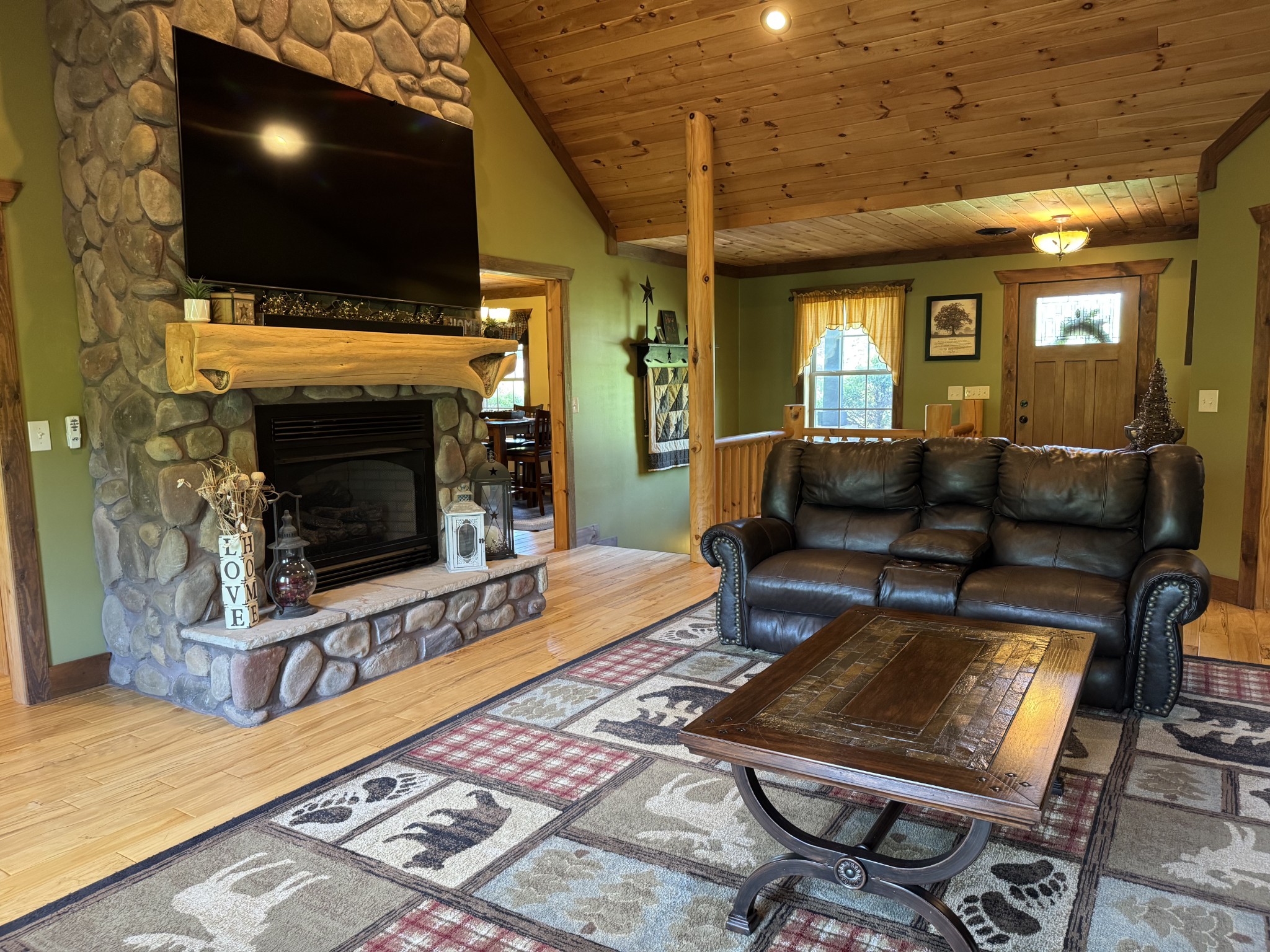 375 Autumn Ridge Lane Lafayette, TN 37083 - Photo 4 of 43 a living room with furniture a flat screen tv and a fireplace