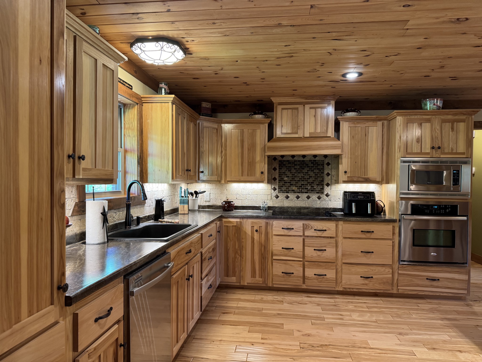 375 Autumn Ridge Lane Lafayette, TN 37083 - Photo 10 of 43 a kitchen with stainless steel appliances granite countertop a stove sink and cabinets