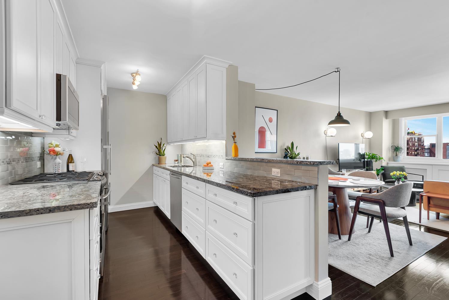 77 7th Avenue, Unit 14L Manhattan, NY 10011 - Photo 3 of 10 a kitchen with a sink stove and cabinets
