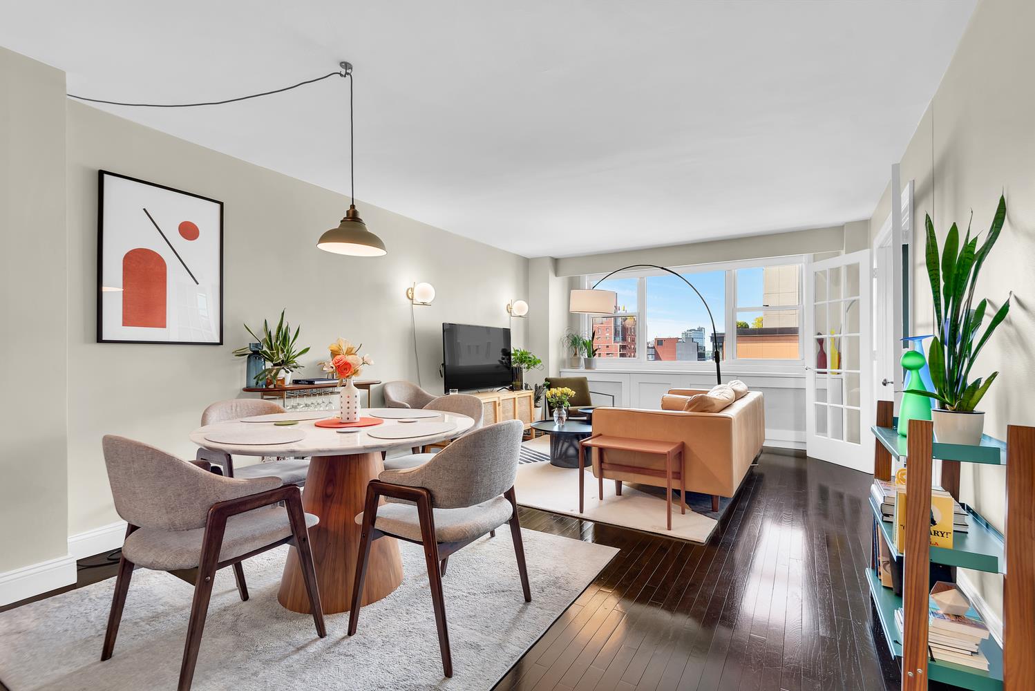 77 7th Avenue, Unit 14L Manhattan, NY 10011 - Photo 4 of 10 a view of a livingroom with furniture window and wooden floor
