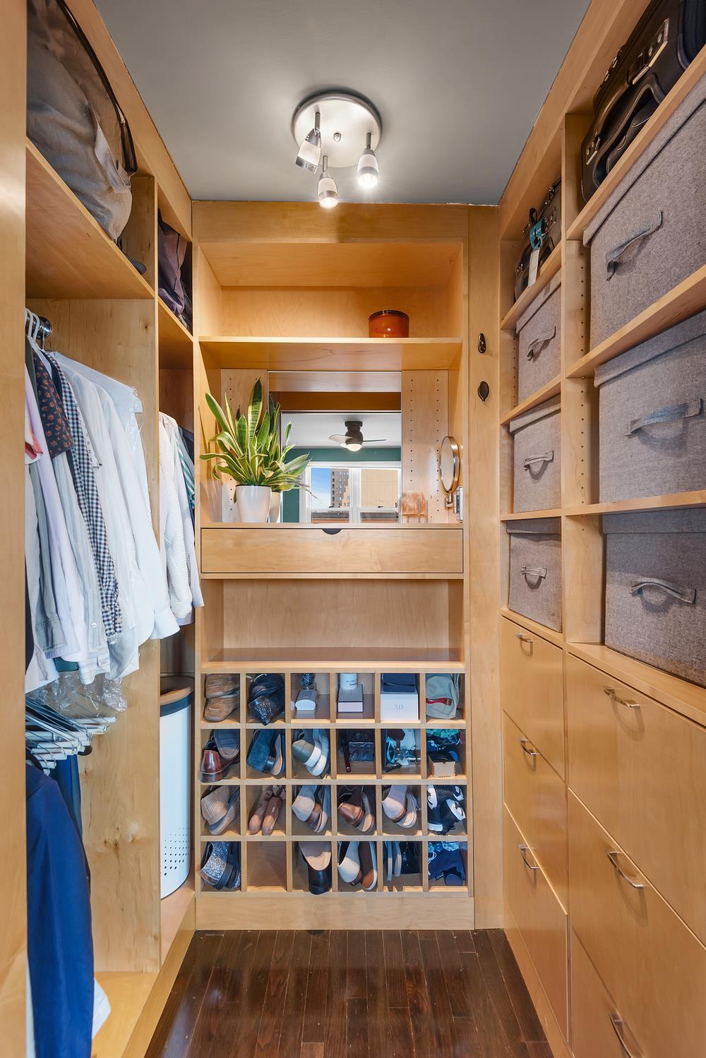 77 7th Avenue, Unit 14L Manhattan, NY 10011 - Photo 5 of 10 a view of a walk in closet with wooden floor