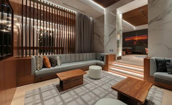 a work room with furniture a flat screen tv and a floor to ceiling window