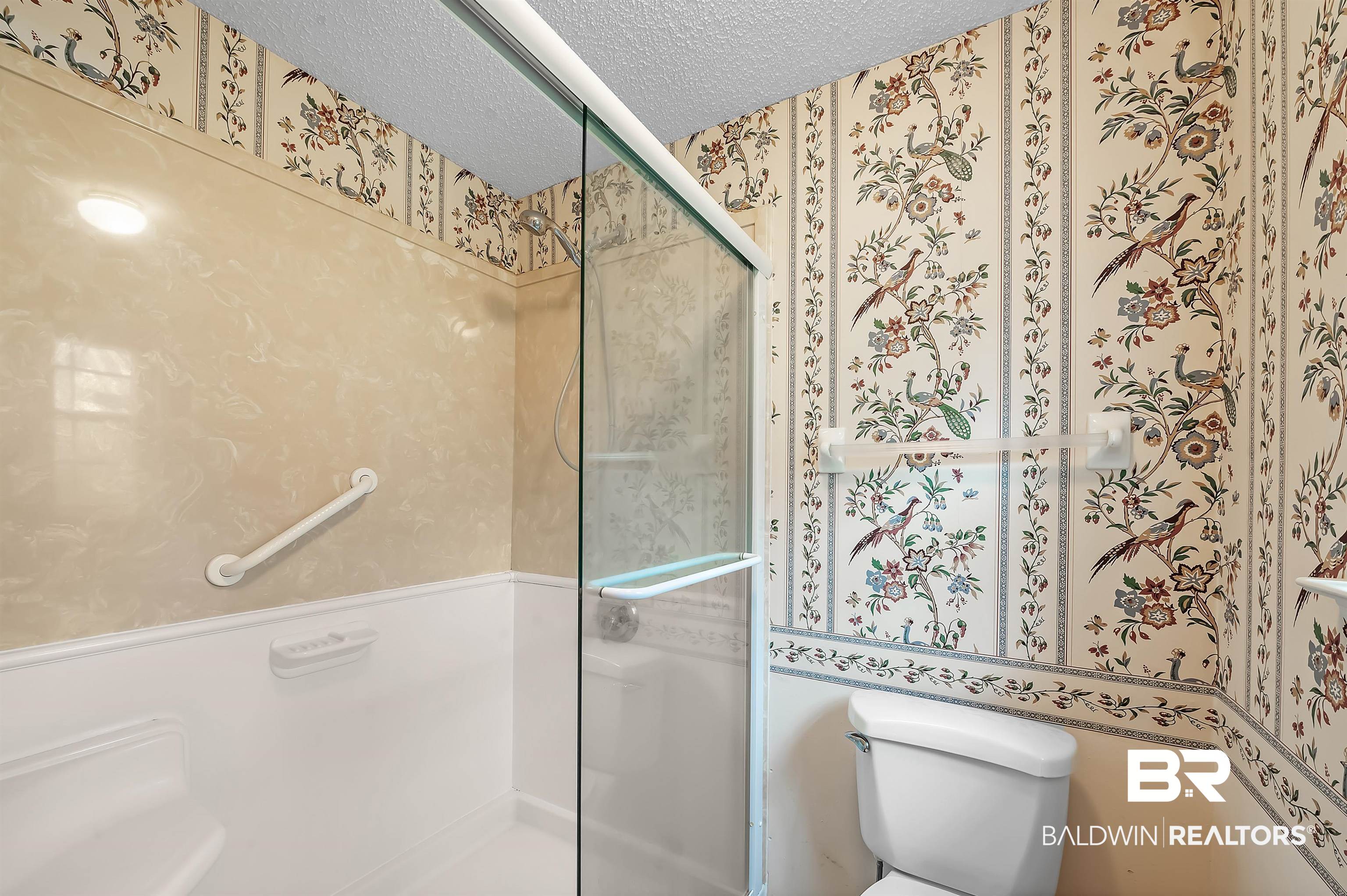 1502 Mulberry Lane Foley, AL 36535 - Photo 26 of 45 Bathroom featuring a shower with shower door, a textured ceiling, and toilet