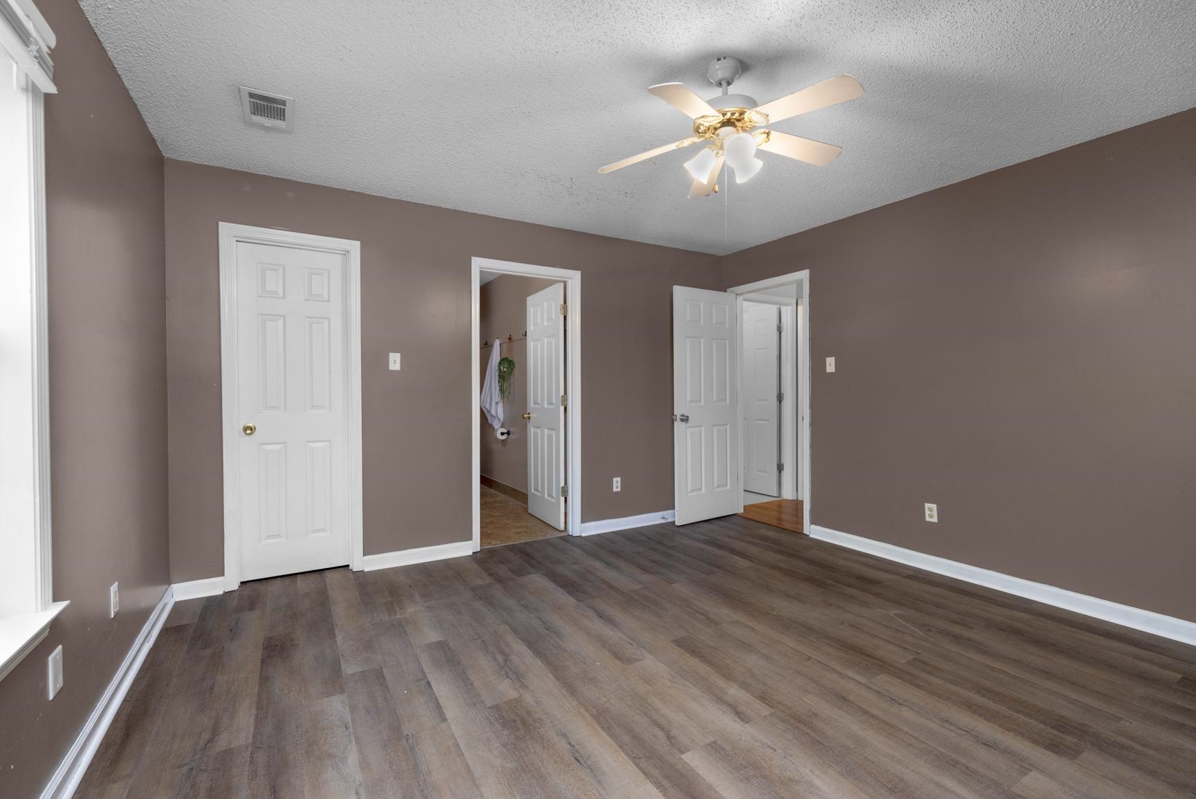 366 Adkins Road Burlison, TN 38015 - Photo 10 of 20 Spacious room featuring wood-finish flooring, neutral wall tones, and white trim
