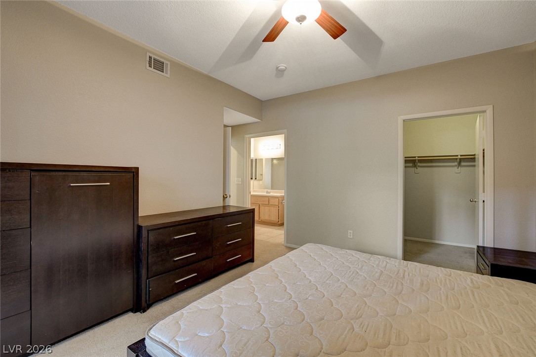9050 West Warm Springs Road, Unit 1034 Las Vegas, NV 89148 - Photo 9 of 17 Well-lit sleeping quarters with a convenient en suite bathroom and ample closet space.