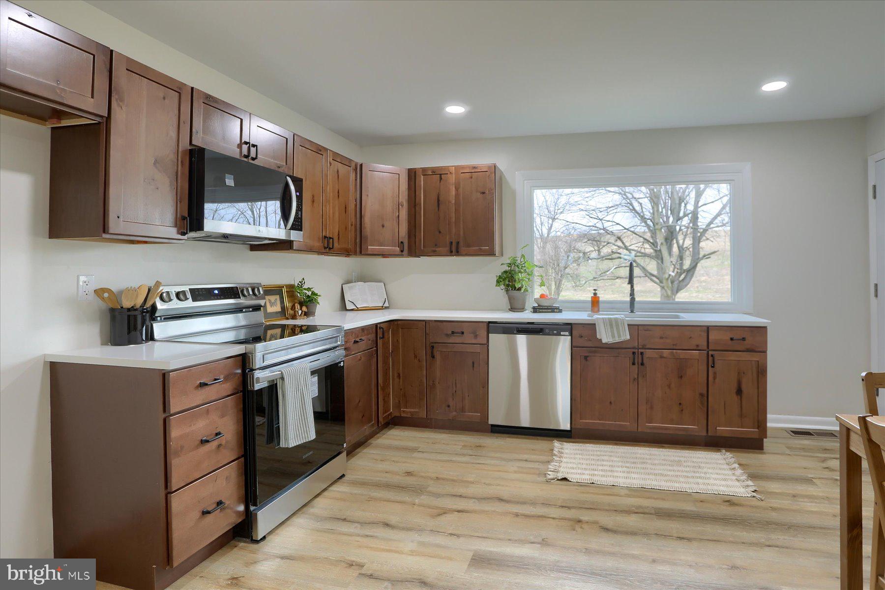 1339 Berrysburg Road Millersburg, PA 17061 - Photo 15 of 42 a kitchen with granite countertop a stove top oven sink and cabinets