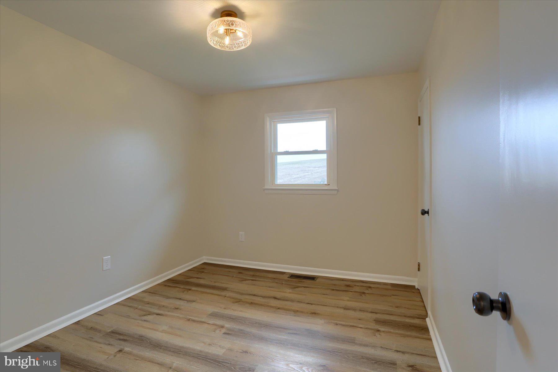 1339 Berrysburg Road Millersburg, PA 17061 - Photo 18 of 42 a view of an empty room with wooden floor and a window
