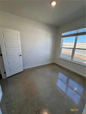 an empty room with a empty space and windows