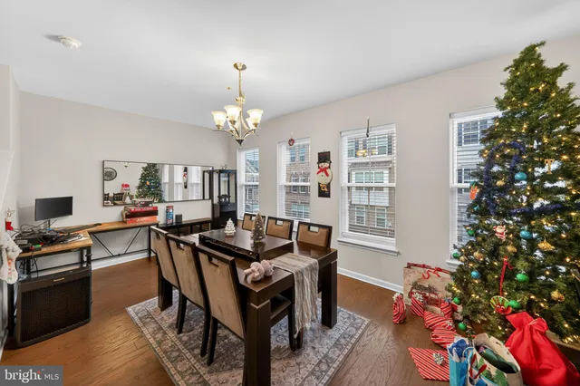 a view of a dining room with furniture and chandelier