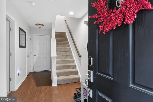 a view of a hallway with wooden floor and stairs