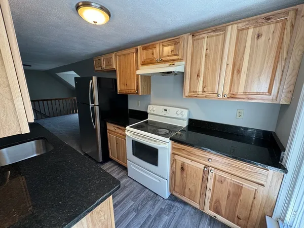 a kitchen with a stove a sink and a microwave