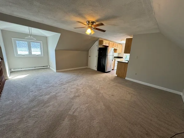 a view of a livingroom with a ceiling fan and window