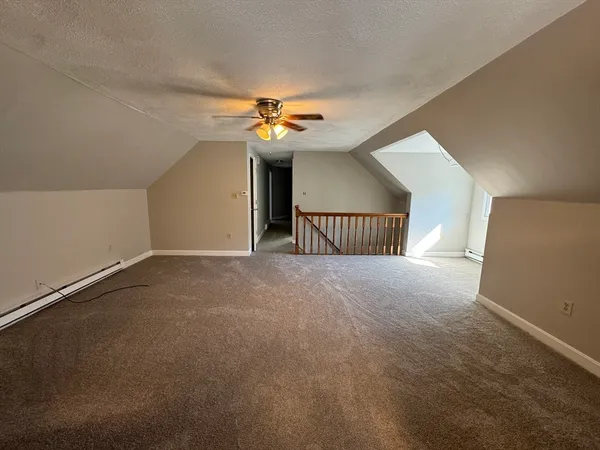 a view of a livingroom with a ceiling fan and window