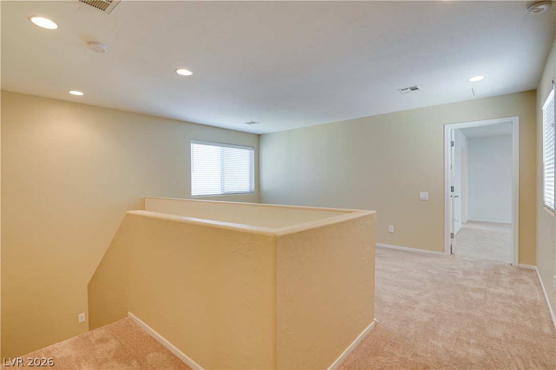 2717 Rimbaud Street Henderson, NV 89044 - Photo 18 of 34 A versatile upstairs loft with plush carpeting and natural illumination awaits your creative vision.