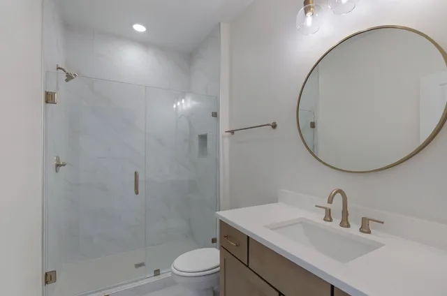 a bathroom with a sink toilet and shower