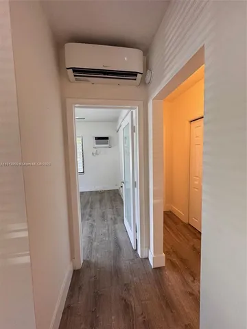 a view of hallway with wooden floor